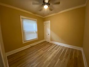 Louisville house for rent - A room with a ceiling fan and a window.