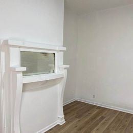 Louisville apartment for rent - A white fireplace with a glass window in the middle.