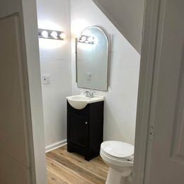 Louisville apartment for rent - A white toilet sits next to a sink in a small bathroom.