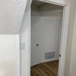 Louisville apartment for rent - A white door is open to a room with a white wall and a white door.