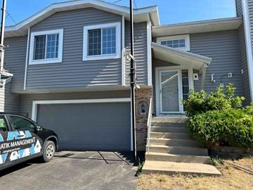 Rochester apartment for rent - a blue house with a car parked in front of it