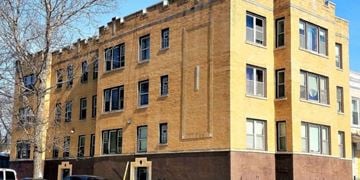 Chicago apartment for rent - A large building with a yellow and brown facade.