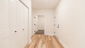 Hudson house for rent - a bedroom with white closets and wood floors