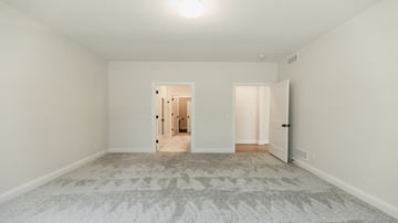 Hudson house for rent - a renovated living room with carpet and white walls