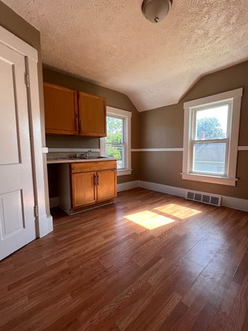 Cleveland apartment for rent - an empty living room with wooden floors and a kitchen