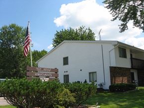 Mayville apartment for rent - a white building with an flag and a sign