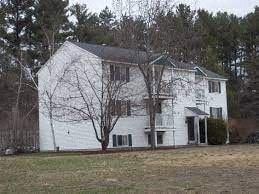 Manchester apartment for rent - A white house with a bare tree in front.