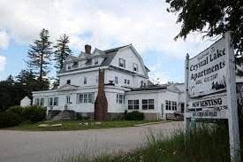 Manchester apartment for rent - A white building with a sign in front that says Coyall Lake Apartments.