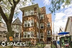 Chicago apartment for rent - a large brick building with a tree in front of it