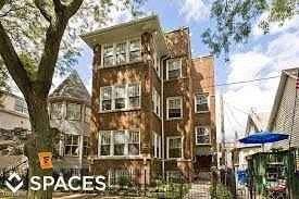 Chicago apartment for rent - a large brick building with a tree in front of it