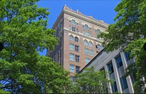 Richmond apartment for rent - a tall brick building with trees in front of it