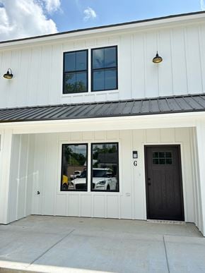 Crowley apartment for rent - the front of a white building with two windows and a black door