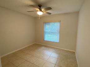 Orlando house for rent - A room with a ceiling fan and a window with blinds.