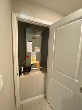 St Cloud house for rent - the back of a furnace in a room with a door