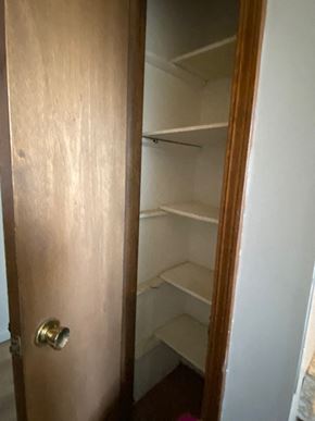 Knob Noster house for rent - A brown door with a handle and a white wall behind it.