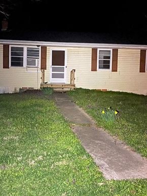 Knob Noster house for rent - A small white door is on the side of a house.