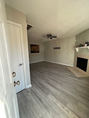 Jacksonville house for rent - A room with a fireplace and a wooden floor.