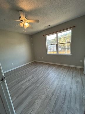 Jacksonville house for rent - A room with a ceiling fan and a window.