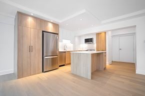 Hampstead apartment for rent - a kitchen with wooden cabinets and a stainless steel refrigerator