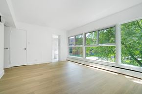 Hampstead apartment for rent - a living room with a large window and wood floors