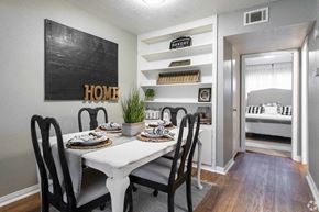 Groves apartment for rent - a dining room with a white table and chairs