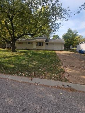 St. Louis house for rent - A house with a tree in front of it.