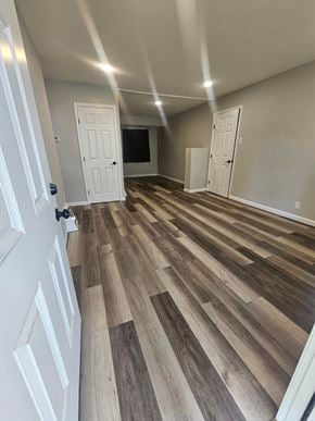 St. Louis house for rent - A room with white doors and wood flooring.