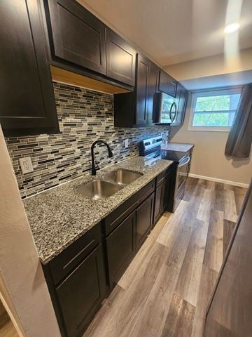 St. Louis house for rent - A kitchen with black cabinets and a granite countertop.