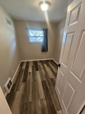 St. Louis house for rent - A room with a wooden floor and a white door.