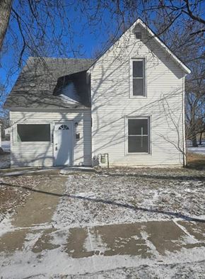 Lima house for rent - A white house with a grey roof and a small porch.