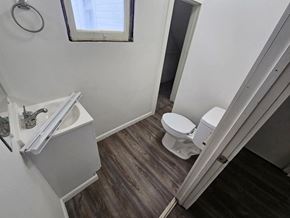 Lima house for rent - A white toilet sits in a bathroom next to a sink.