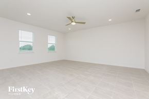 Kissimmee house for rent - a living room with white walls and a ceiling fan