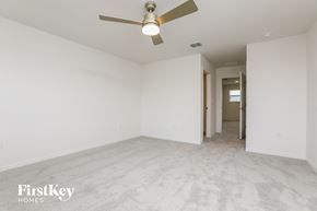Kissimmee house for rent - a clean and empty living room with a ceiling fan