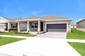 Kissimmee house for rent - a house with a driveway and a garage door