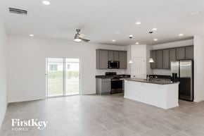 Kissimmee house for rent - an open kitchen with a large island and stainless steel appliances