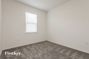 Bartow house for rent - a bedroom with white walls and carpet and a window