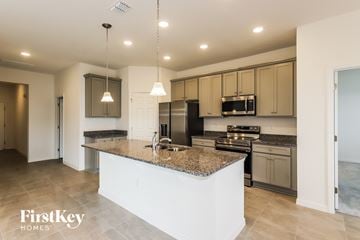Bartow house for rent - a kitchen with granite counter tops and stainless steel appliances
