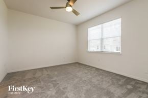 Bartow house for rent - a bedroom with a ceiling fan and a window
