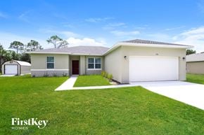 Palm Bay house for rent - A house with a garage and a driveway in front of it.