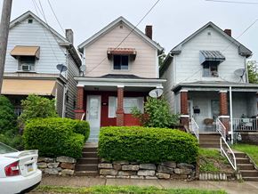 Clairton house for rent - A white car is parked in front of a house.