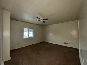 Clairton house for rent - A room with a ceiling fan and a window.