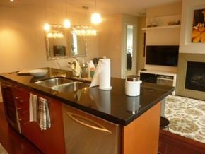 Vancouver apartment for rent - a kitchen with a black counter top and a sink