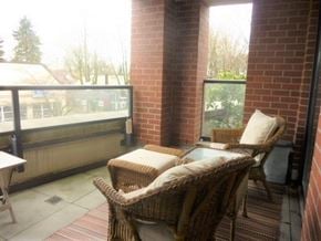 Vancouver apartment for rent - a patio with wicker chairs and a glass table
