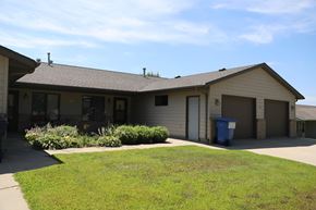 Dell Rapids apartment for rent - A house with a blue trash bin in front.