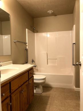 Dell Rapids apartment for rent - a bathroom with a toilet and a tub and a sink
