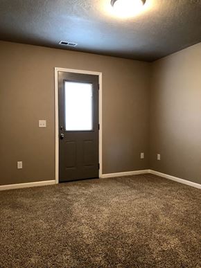 Dell Rapids apartment for rent - a empty room with a door and a window