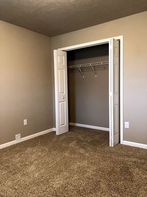 Dell Rapids apartment for rent - an empty bedroom with a closet with a white door