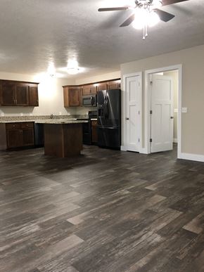 Dell Rapids apartment for rent - A kitchen with wood floors and a ceiling fan.