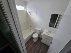 Las Vegas apartment for rent - A small bathroom with a toilet, sink and bathtub.