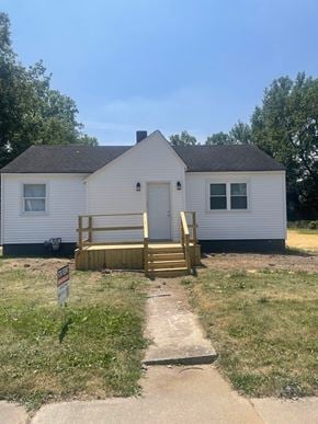 Lima house for rent - A small white house with a brown door and a wooden porch.